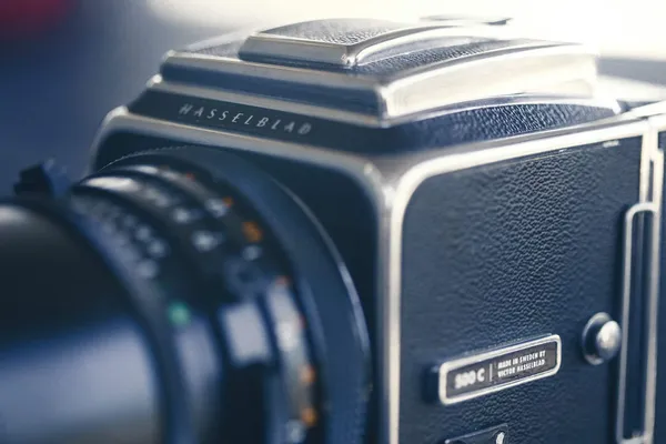 Vintage film camera and boudoir photography setup with natural light